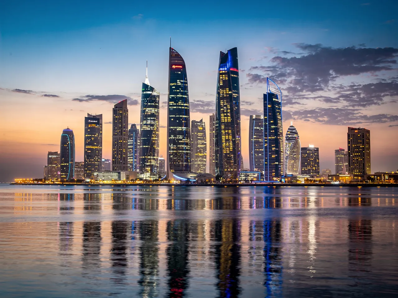 Doha skyline at dusk, representing the business environment.